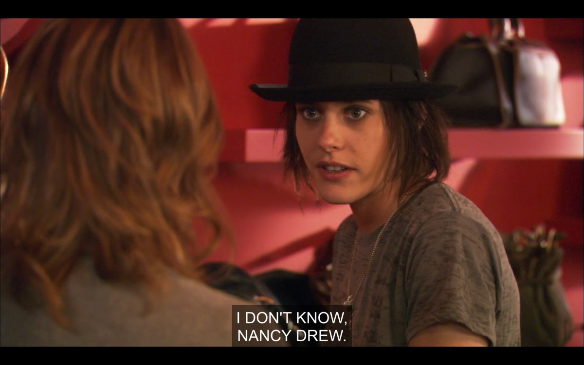 Shane (wearing a grey t-shirt and a black fedora) and Alice (back to the camera) at a shoe store. Shane says, "I don't know, Nancy Drew."