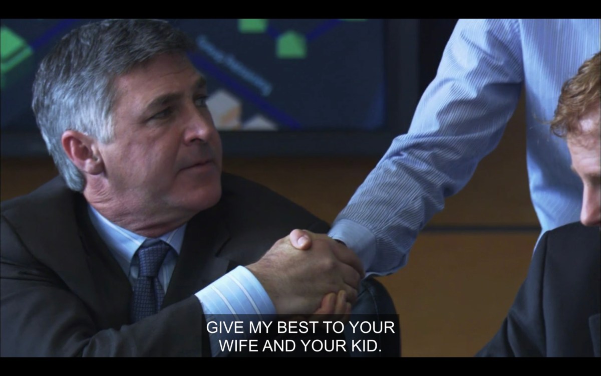 Max's arm reaching down to shake his boss's hand, who is wearing a full suit and sitting at a conference table. Max says, "Give my best to your wife and your kid."