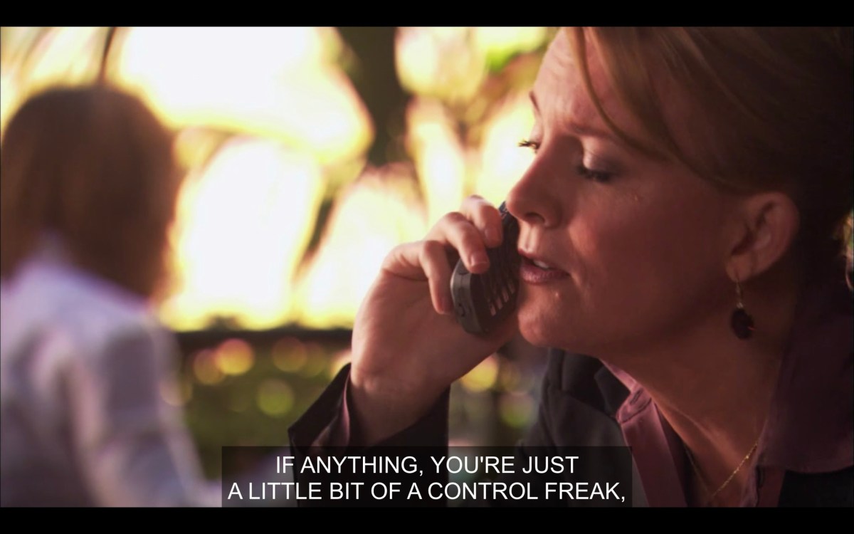 Tina, outside, talking on her cell phone to Bette. Tina says into the phone, "If anything, you're just a little bit of a control freak."