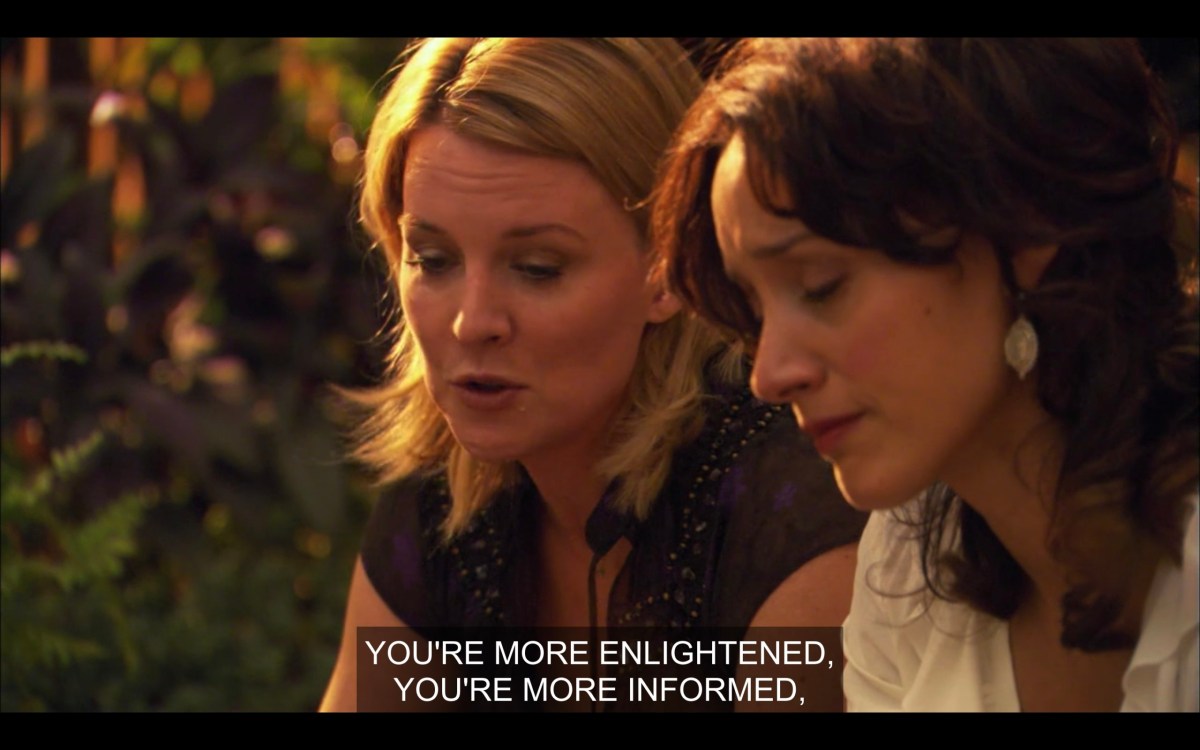 Tina (wearing a black top) and Bette (wearing a white top) sit outside next to each other. Tina says, "You're more enlightened, you're more informed,"