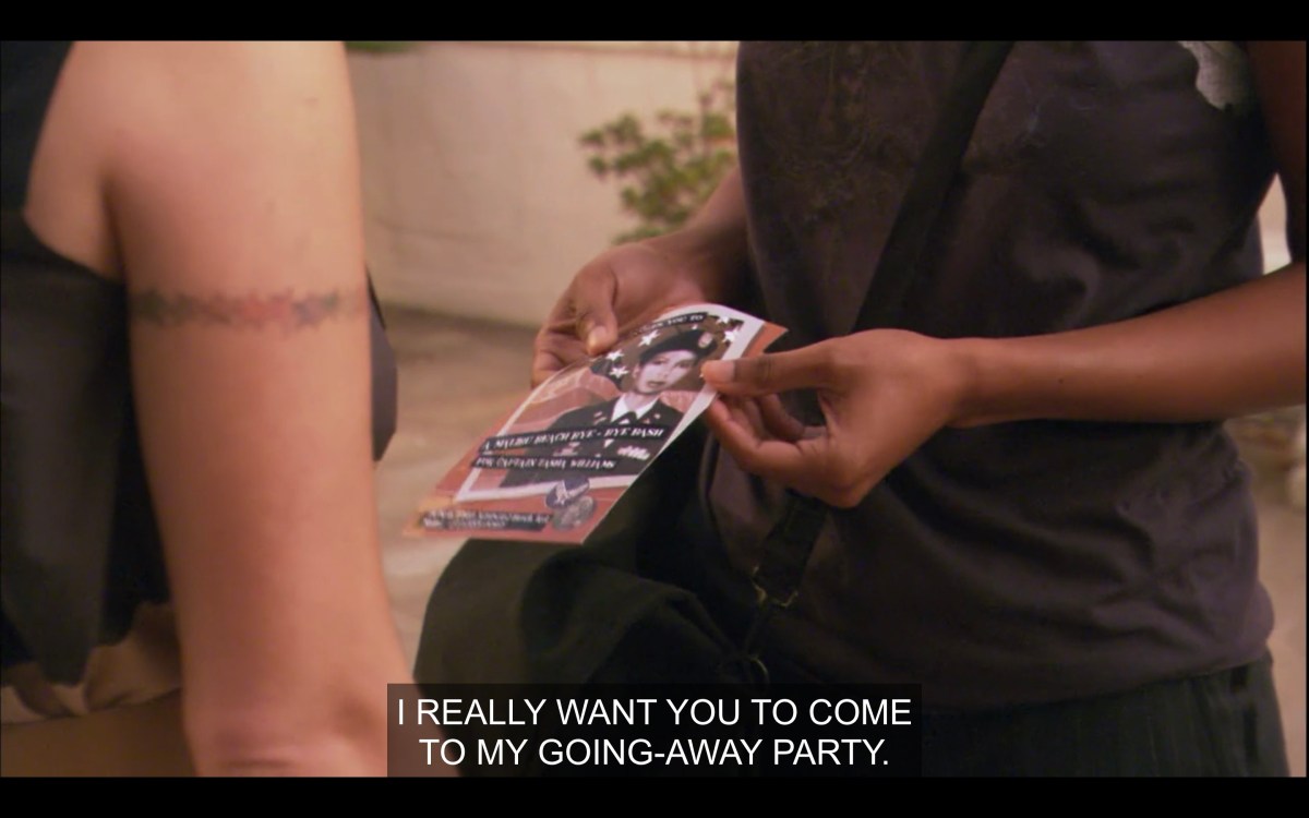 Alice's arm (featuring her rainbow star tattoo on her right upper arm) and Tasha's torso in a black shirt. Tasha is holding a party invitation (with a picture of her in her army uniform on it) in her hands. Tasha says, "I really want you to come to my going-away party."