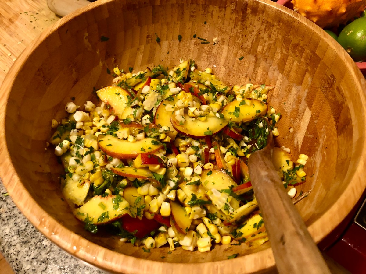 grilled corn and peach salad with herbs and queso fresco in a bowl