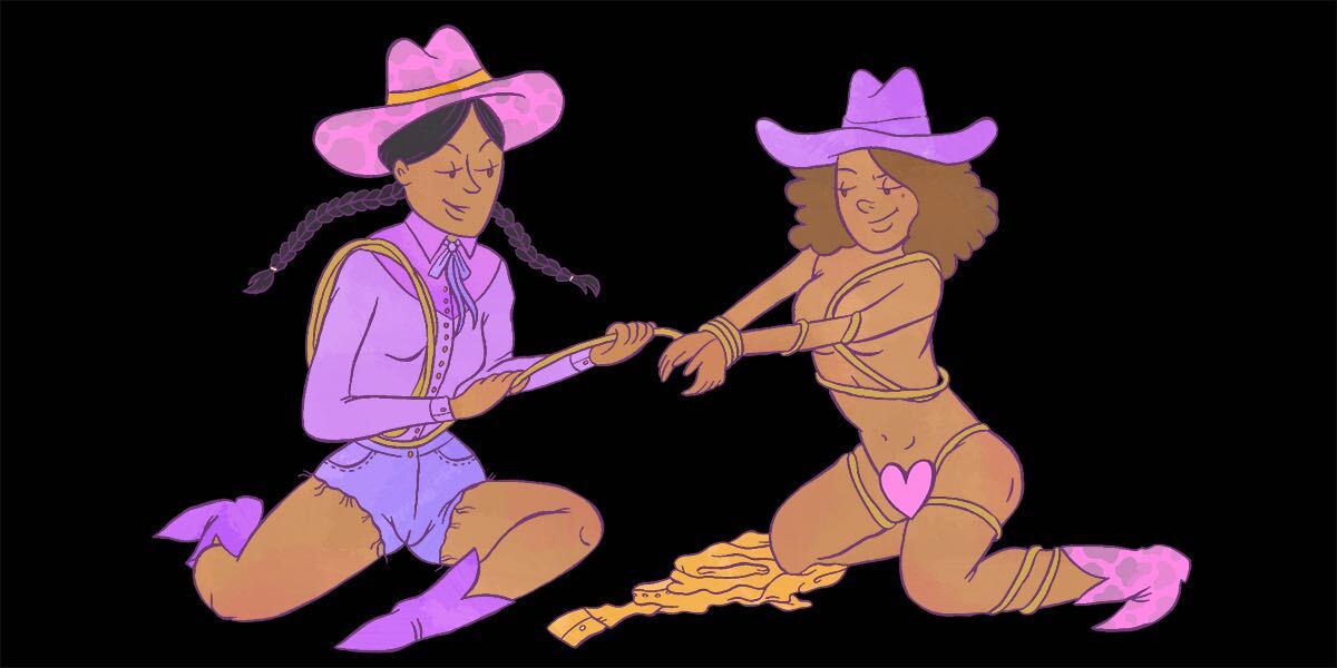 two cow girls sitting on the floor, one tying the wrists of the other with a rope