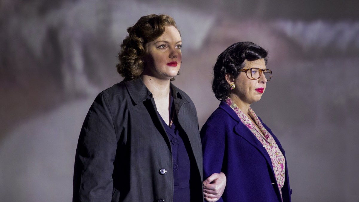 Shannon Purser as Del Martin and Heather Matarazzo as Phyllis Lyon. Arms linked, wearing trench-coats and other '50s-era attire.