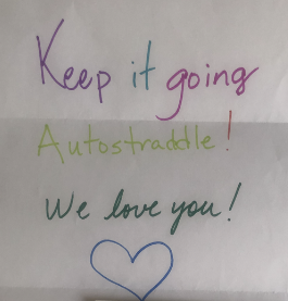 A handwritten note in rainbow letters says Keep it going Autostraddle! We love you! with a heart drawn as well.