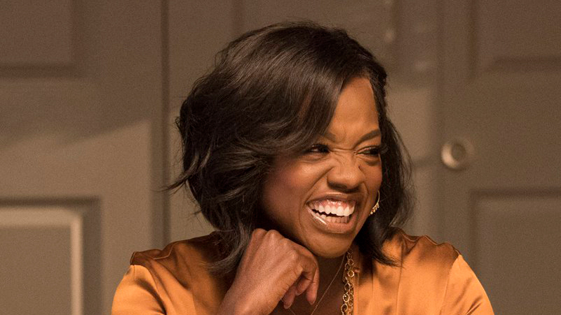 Annalise Keating from "How to Get Away with Murder" glows in golden light while talking with her friends over a holiday dinner.