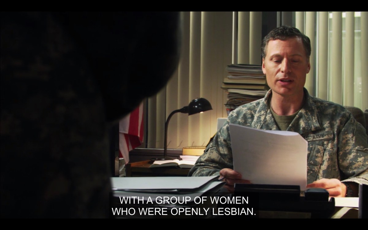 Beech in his office at the military base reading from a package of papers, "with a group of women who were openly lesbian"