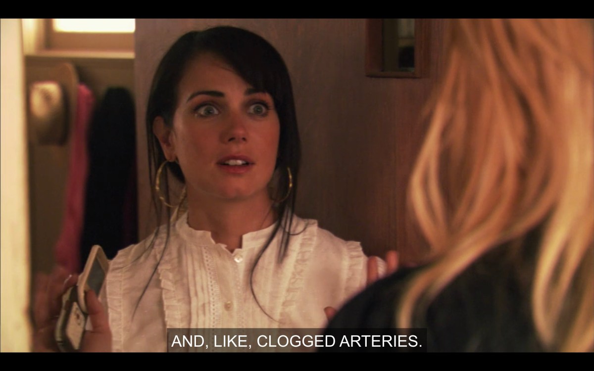 Jenny's eyes bugged out, wearing a lacy shirt, opening the door to her house. She is talking about clogged arteries.