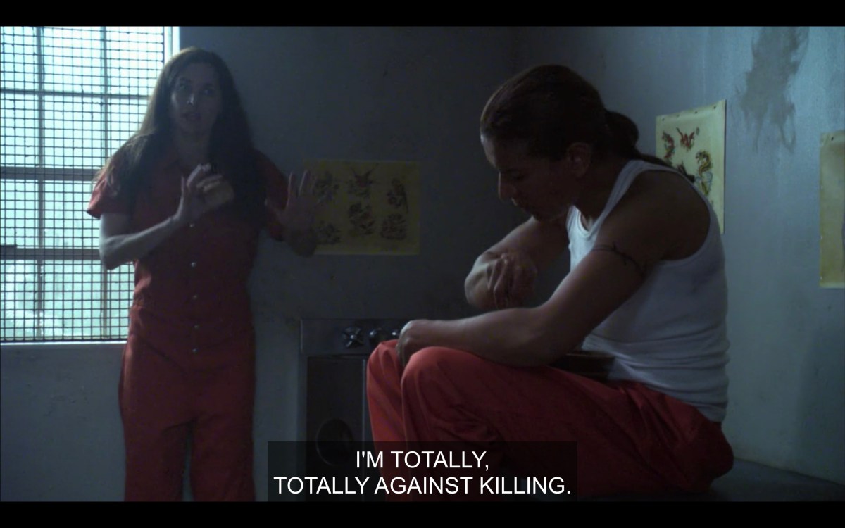 Helena and Dusty in a jail cell, Dusty sitting and eating, Helena standing looking nervous, saying "I'm totally totally against killing."