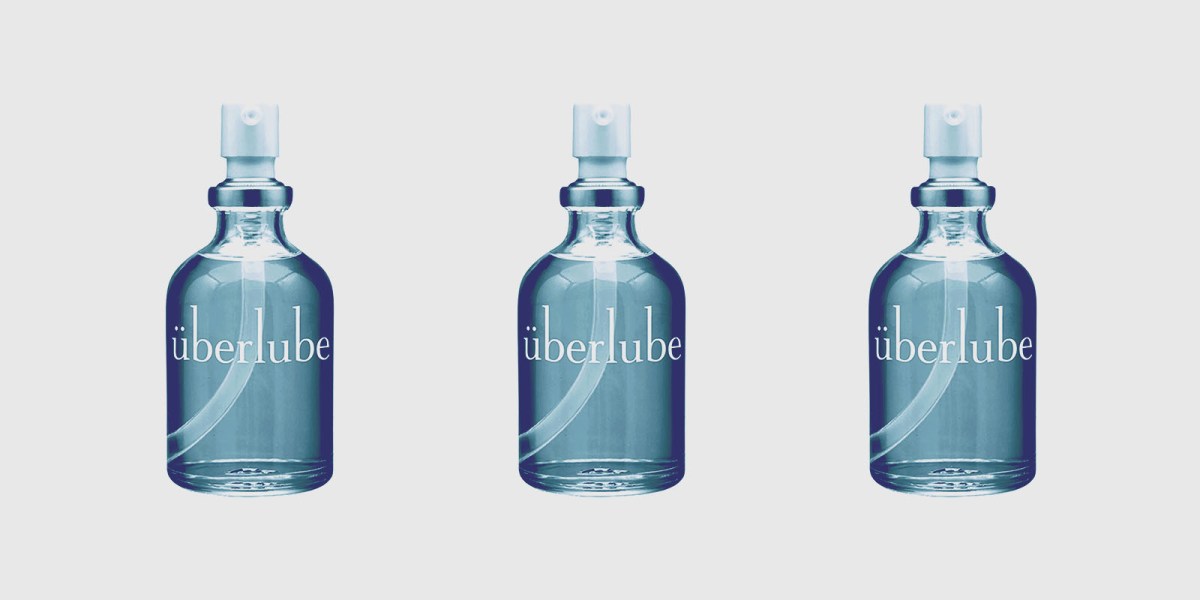 Three bottles of Uberlube, a translucent liquid in a clear glass container with a pump top