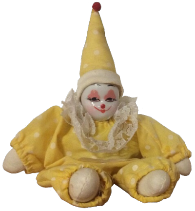 a small yellow clown doll with a ceramic face and fabric body and a knowing smile