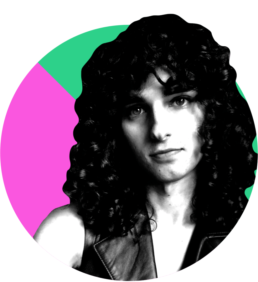 Drew Gregory, looking fab, serious and thoughtful with the hair of a goddess in black and white against a pink and green background.