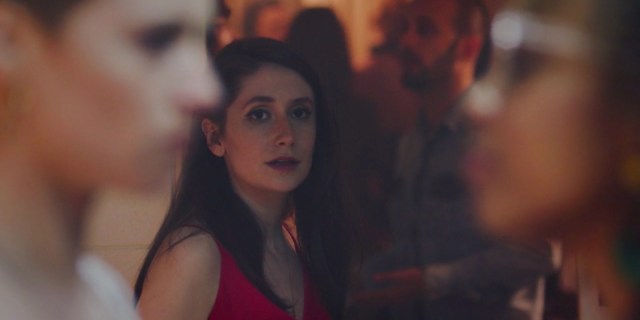Charly Clive as Marnie in HBO Max's new series "Pure." Marnie is in the background as she longs for two women, both blurry to the camera, in the foreground