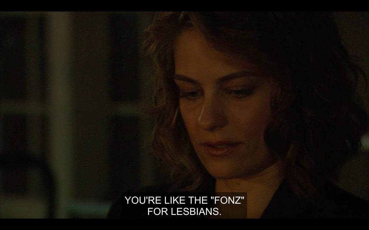 Molly on set, telling Shane that she knows she's like "the fonz for lesbians"