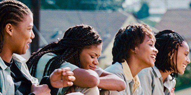 The cast of Set It Off — Queen Latifah as Cleo, Kimberely Elise as TT, Vivica A. Fox as Frankie, and Jada Pinkett Smith as Cleo — sit together laughing on a roof.