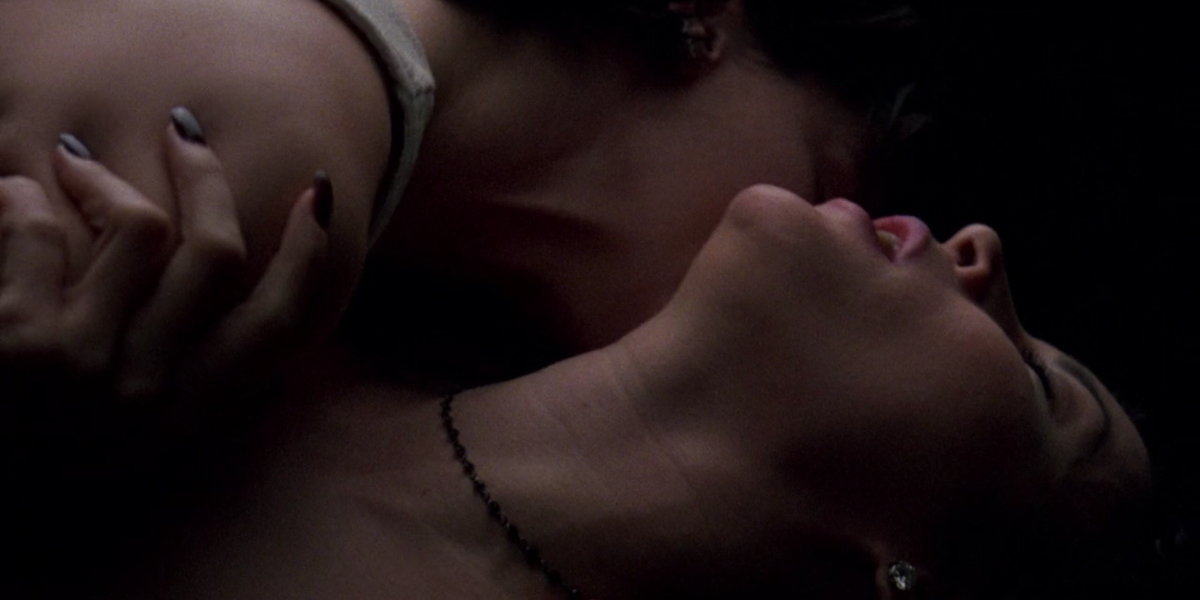 Lesbian Sex Scenes: Jennifer Tilly tilts her head back as Gina Gershon kisses her neck.