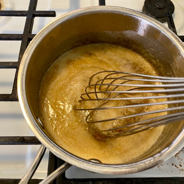 a pot with butter browning and a whisk stirring it up