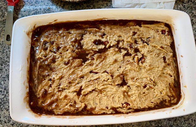 a full casserole pan with a pale blondie batter on top, and a darker layer of browned butter seeping up from beneath