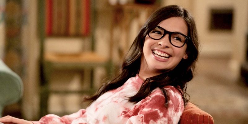 Elena Alvarez is getting hyped about watching One Day at a Time on CBS. She smiles the biggest dork smile and has on a tie-dye pink shirt.