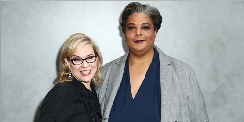 Roxane Gay and Debbie Millman standing against a grey wall.