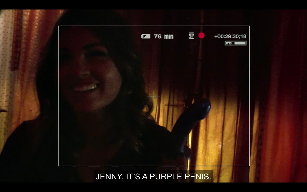 Jenny filming Niki holding a purple dildo