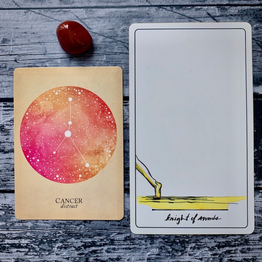 The Cancer card from the Constellations deck and the Knight of Swords card
