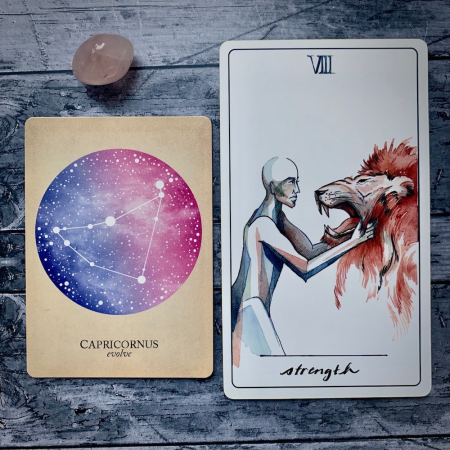 the Capricorn card in the Constellations deck and the Strength card