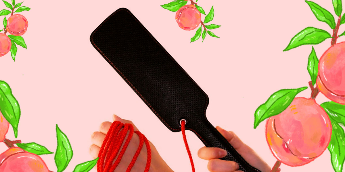 Scarlet Couture Paddle - a black paddle with a red rope attached.