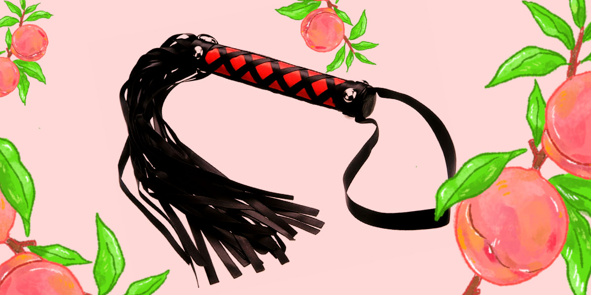 Tantric Satin Pleasure Whip - a red and black pattern on the handle, with all-black tails