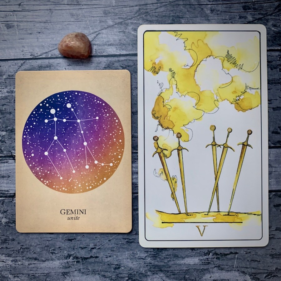 A Gemini card from the Constellations deck and the 5 of Swords card
