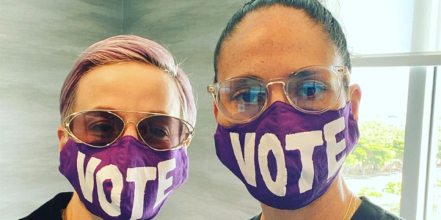 Sue Bird and Megan Rapinoe wearing face masks that say "vote."