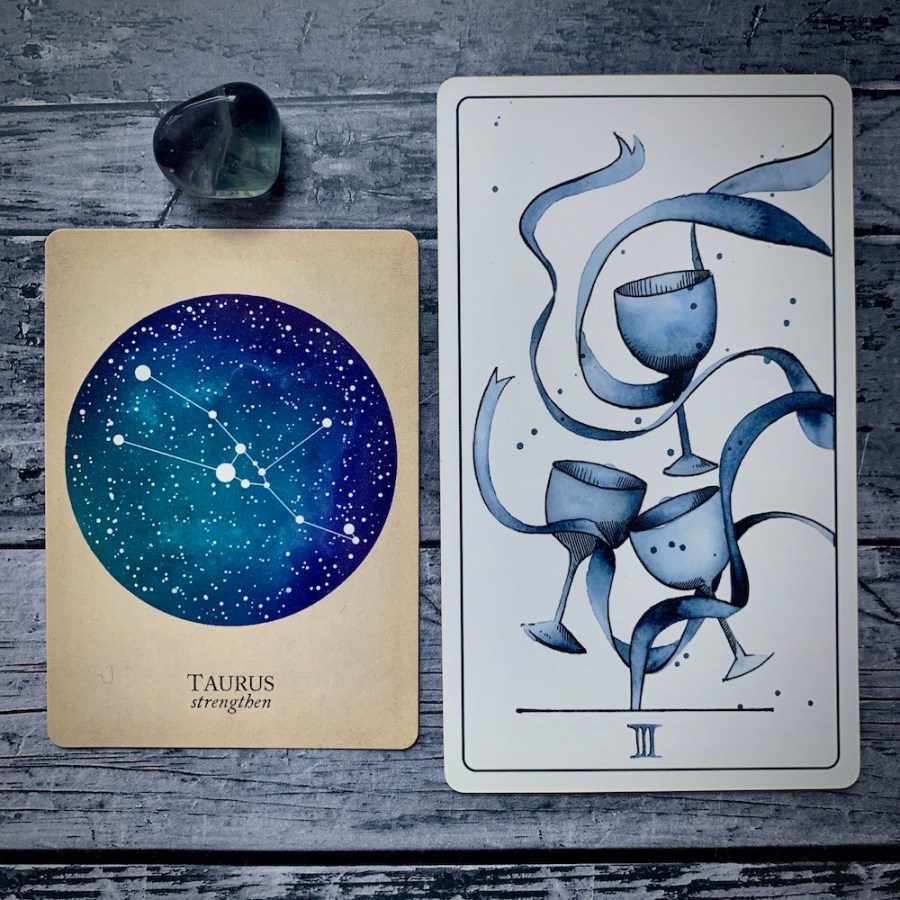 A Taurus card from the Constellations deck and a 3 of Cups card