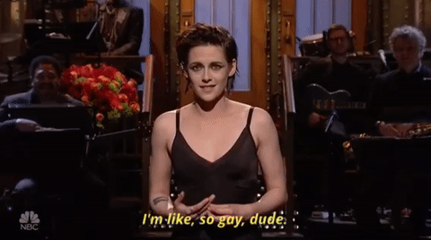 Kristen Stewart stands on stage during her opening monologue on Saturday Night Life, saying "I'm like, so gay dude."