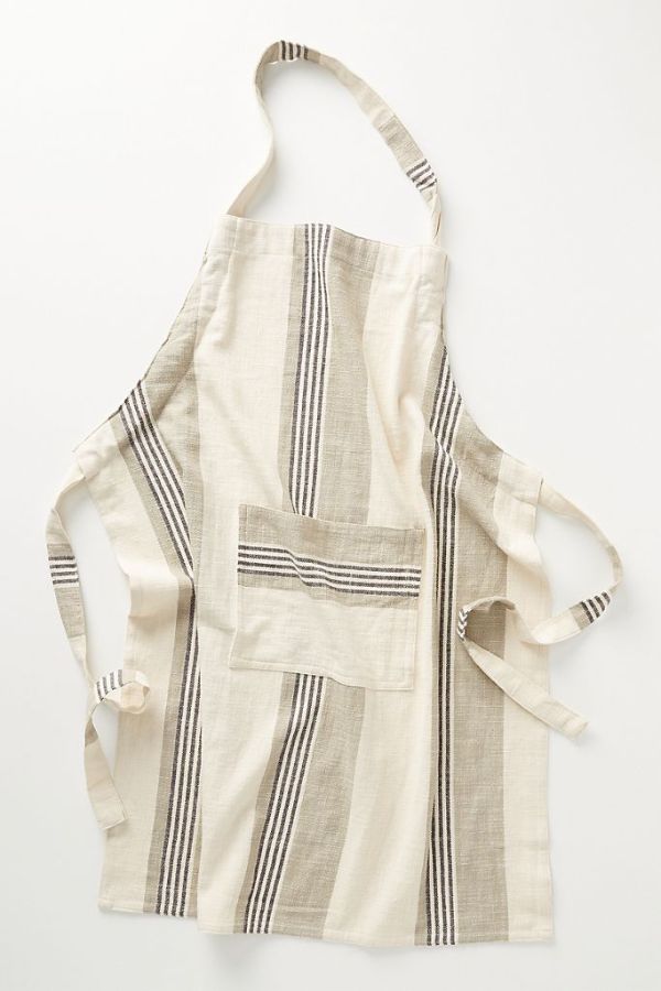 A multicolored stripped apron in cream and shades of grey.