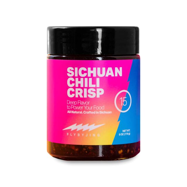 A small bottle of Sichuan Chili Crisp spices with a bright multicolored neon pink label.