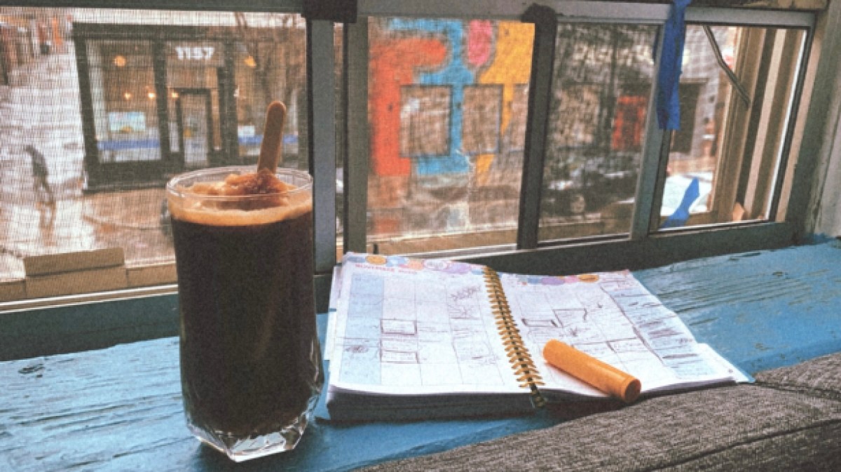 An image showing a glass filled with ice coffee and an ice cream bar. Next to it is a full calender and the background is a city street through the view of a window.