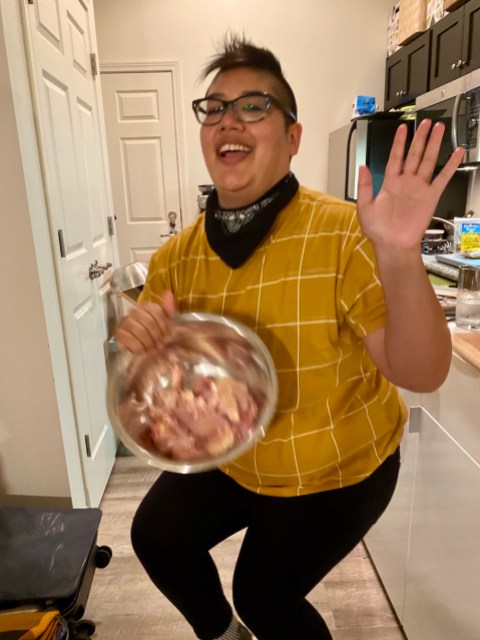 kamala shakes a bowl of chicken around and dances