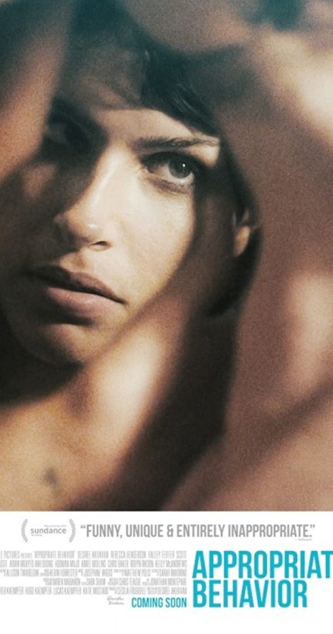 A photo of the poster for the film Appropriate Behavior, it shows a close up of a womans face with hands in the frame and lists text with the names and titles of the cast, crew and other production members.