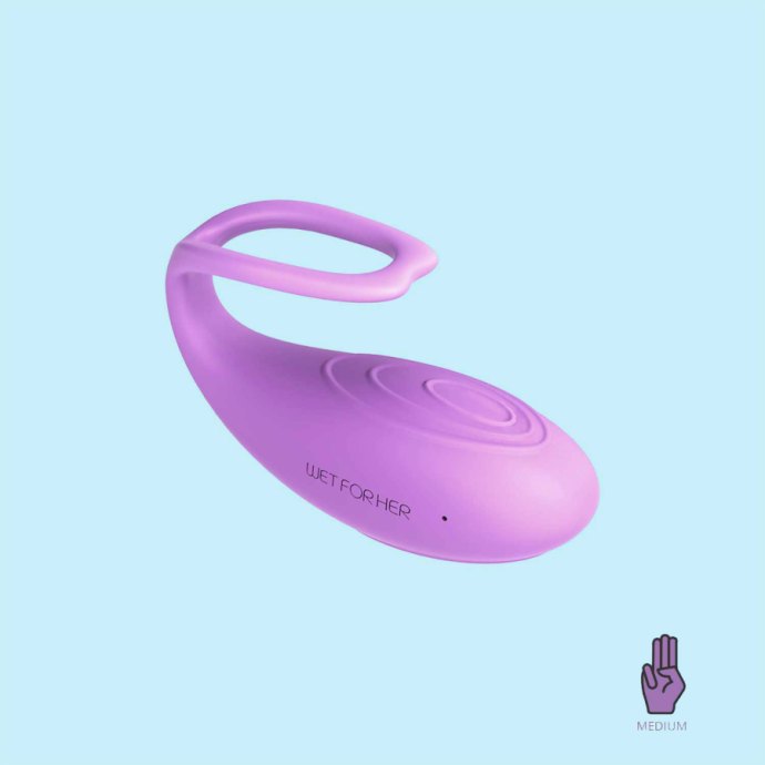 Small purple vibrating oval shaped toy. There is a tail like end with a loop for grabbing.