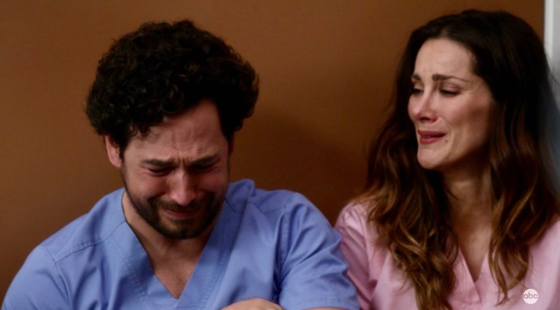 Carina DeLuca cries on the floor with her brother in a hospital lounge on "Grey's Anatomy"