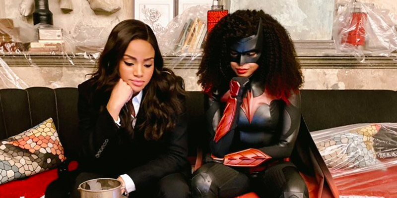 Meagan Tandy as Sophie Moore and Javicia Leslie as Batwoman, in costume, looking at the election results on-set.