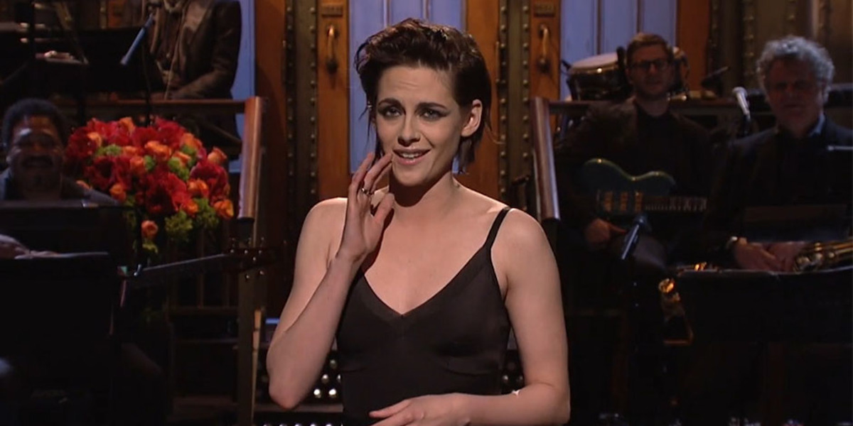 Kristen Stewart hosting Saturday Night Live in 2017. She holds her hand up to her mouth to amplify, "I'm like, so gay, dude." It's an iconic moment of lesbian pop culture history.