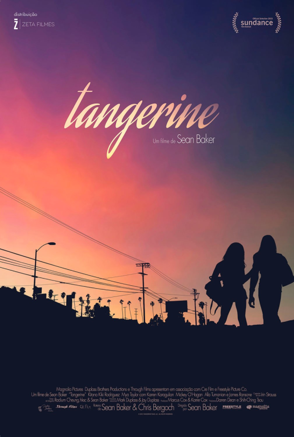 Photo shows two women and their silhouettes while the sky is a color of orange and purple behind them.