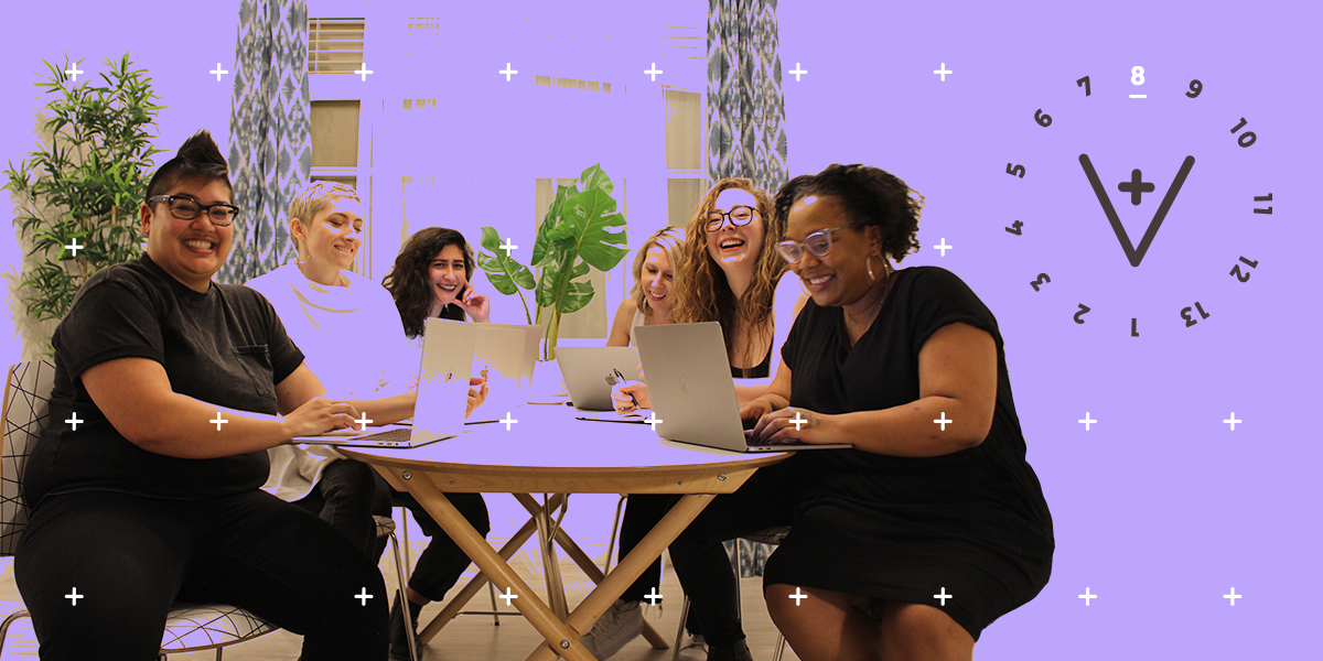 The team: Kamala, Sarah, Riese, Laneia, Rachel, Carmen gathers around a table at their last staff retreat, laughing and working on their computers. This image has the 13 Days of A+ treatment with a lavender wash and the A+ logo indicating that it is day 8