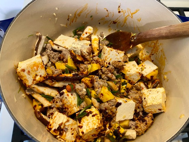 mapo tofu in the making! pot with tofu chunks, pork, squash, shiitakes and chilies