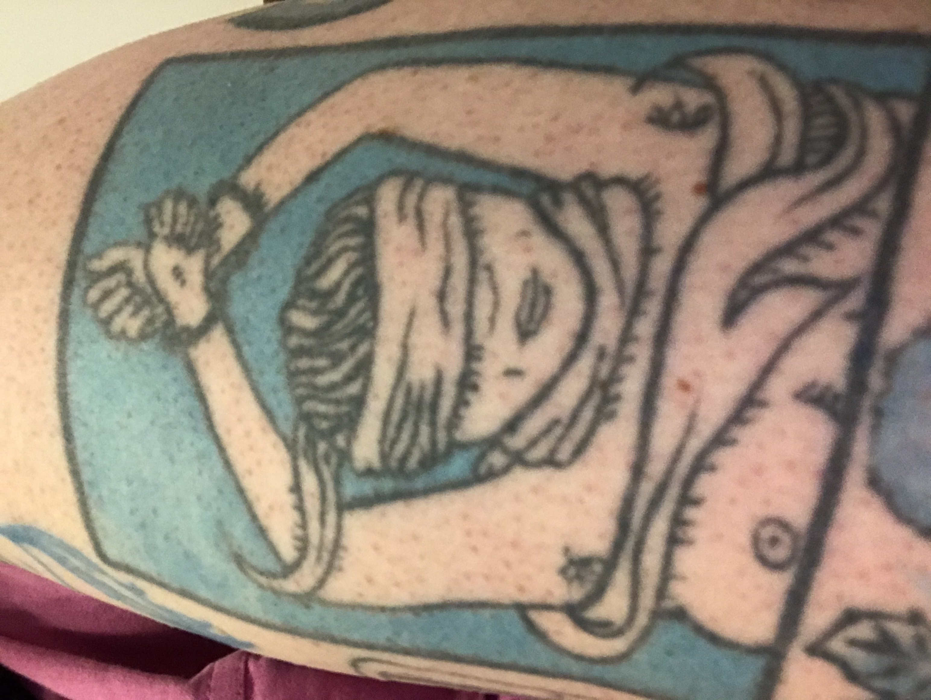 a photo of Kathleens tattoo of a woman whose wrists are tied above her head and blind-folded, and one of her breasts is falling out of a shirt, exposing a nipple. Kathleen is a contributor to Best Lesbian Erotica Vol 5 