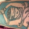 a photo of Kathleens tattoo of a woman whose wrists are tied above her head and blind-folded, and one of her breasts is falling out of a shirt, exposing a nipple. Kathleen is a contributor to Best Lesbian Erotica Vol 5 