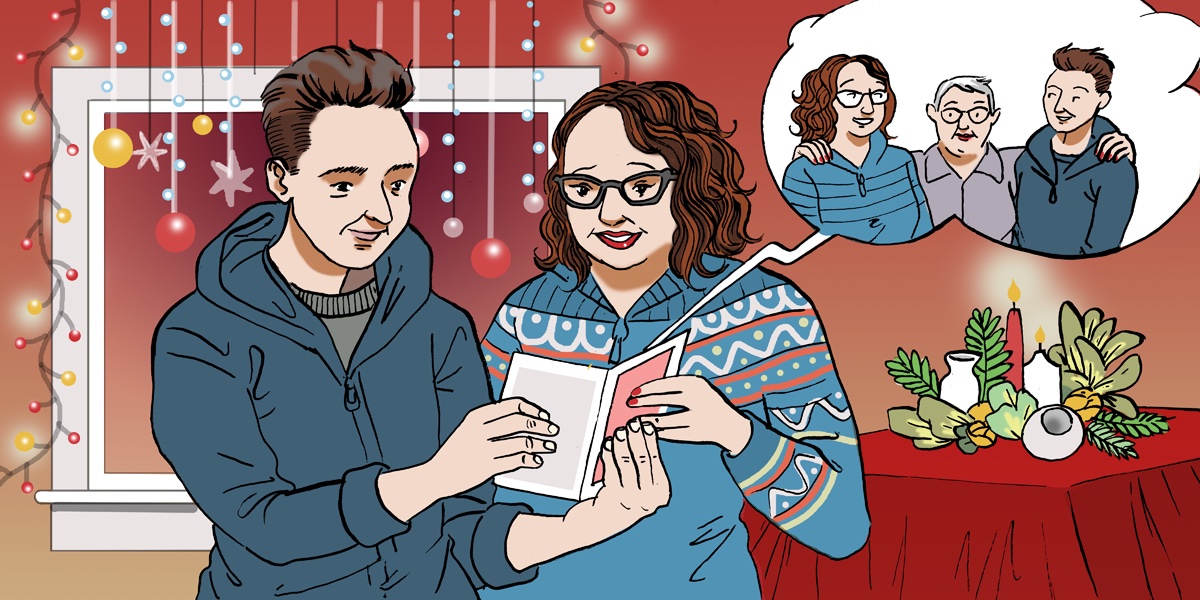 Two people reading a Christmas card.