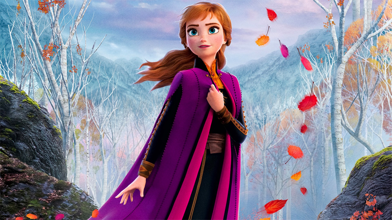 Anna stands in a forest surrounded by swirling autumn leaves. More attention has been paid to lesbian Disney characters like Elsa than bisexual Disney characters like Anna. 