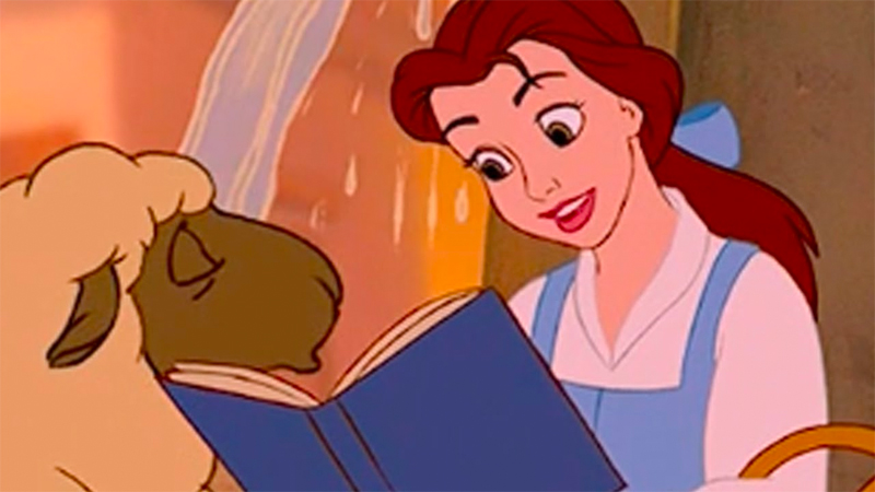 Belle reads to a sheep. 
